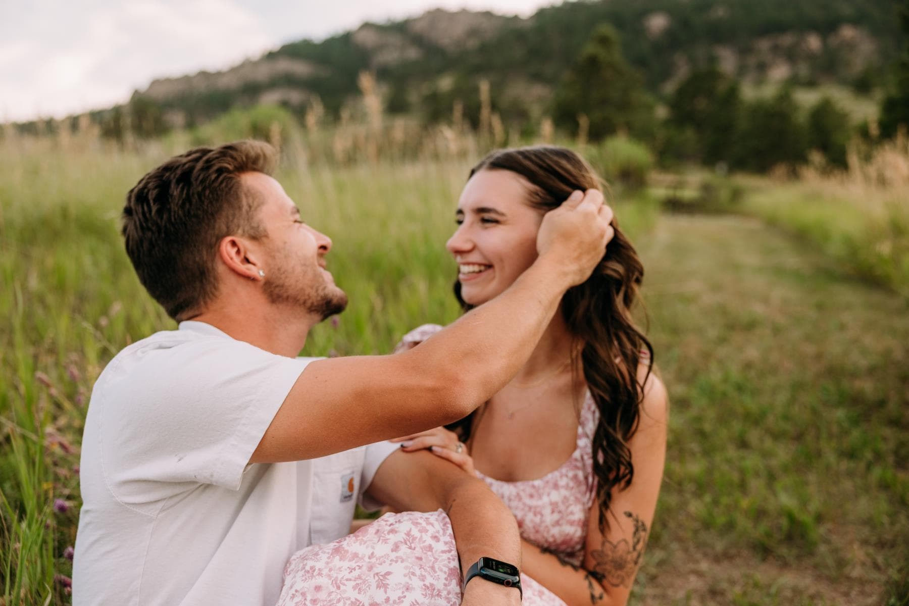 Engagement session couple kissing wildflower field Colorado