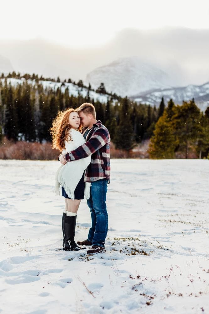 Couple laughing together golden hour engagement session Northern Colorado
