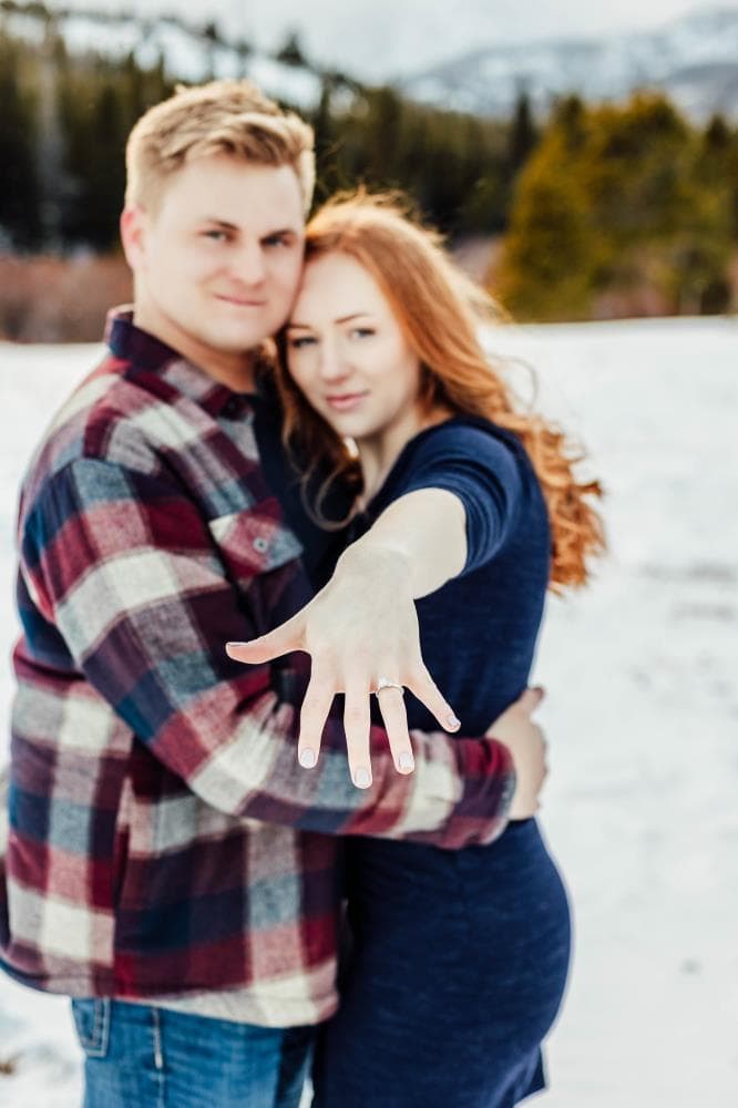 Engagement session couple kissing wildflower field Colorado