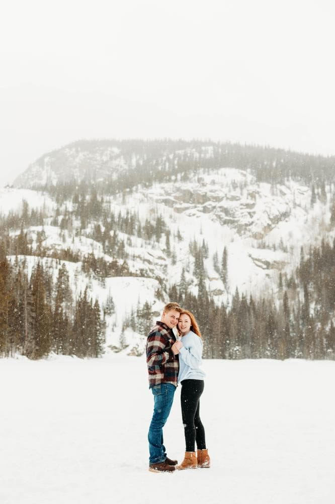 Engagement session couple kissing wildflower field Colorado