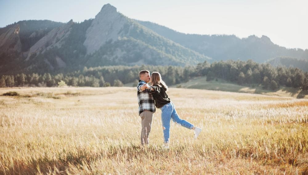 Couple laughing together golden hour engagement session Northern Colorado