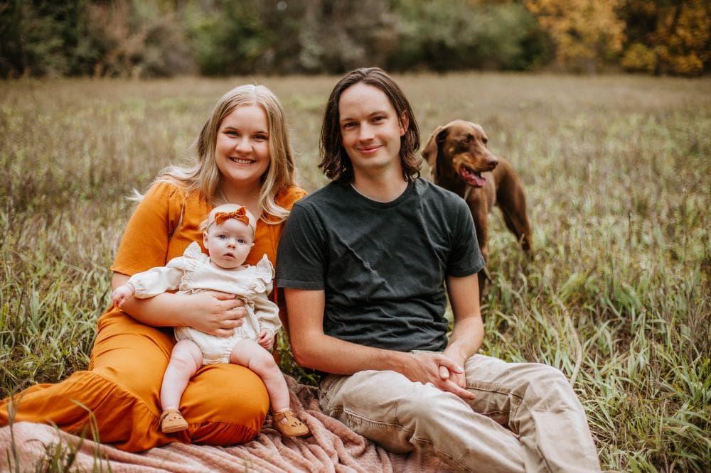 Family of four hugging outdoor portrait session Windsor Colorado