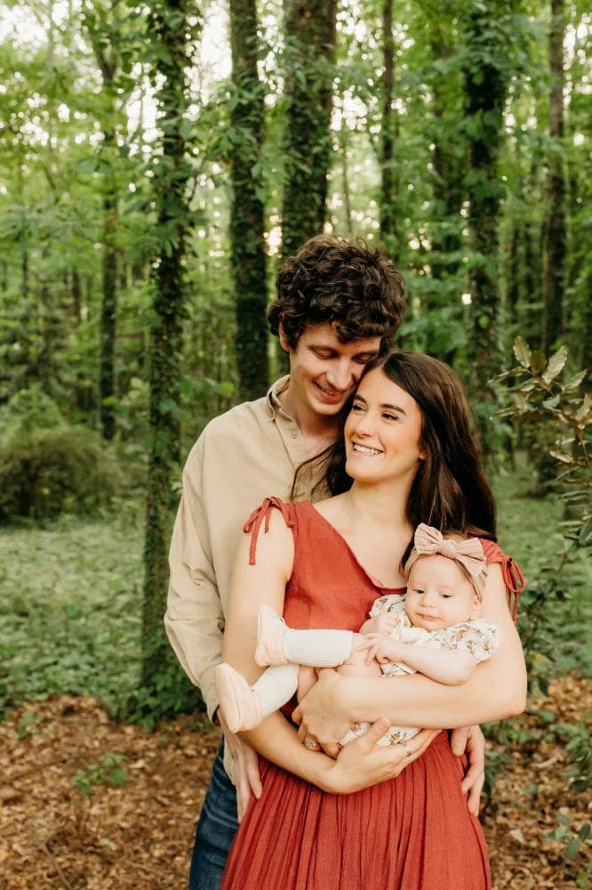 Family of four hugging outdoor portrait session Windsor Colorado