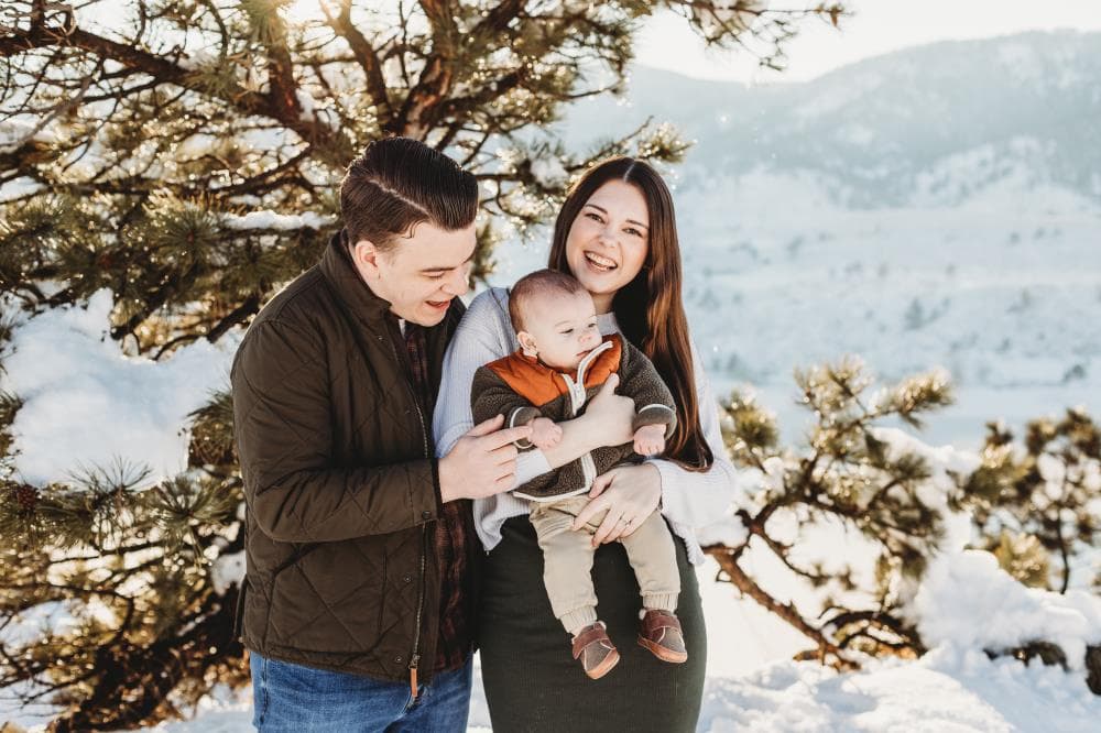 Family of four hugging outdoor portrait session Windsor Colorado