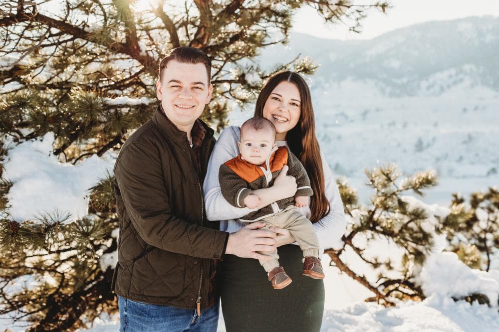 Family of four hugging outdoor portrait session Windsor Colorado