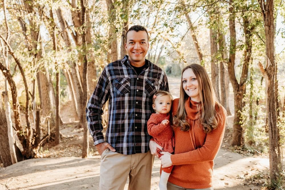 Family of four hugging outdoor portrait session Windsor Colorado