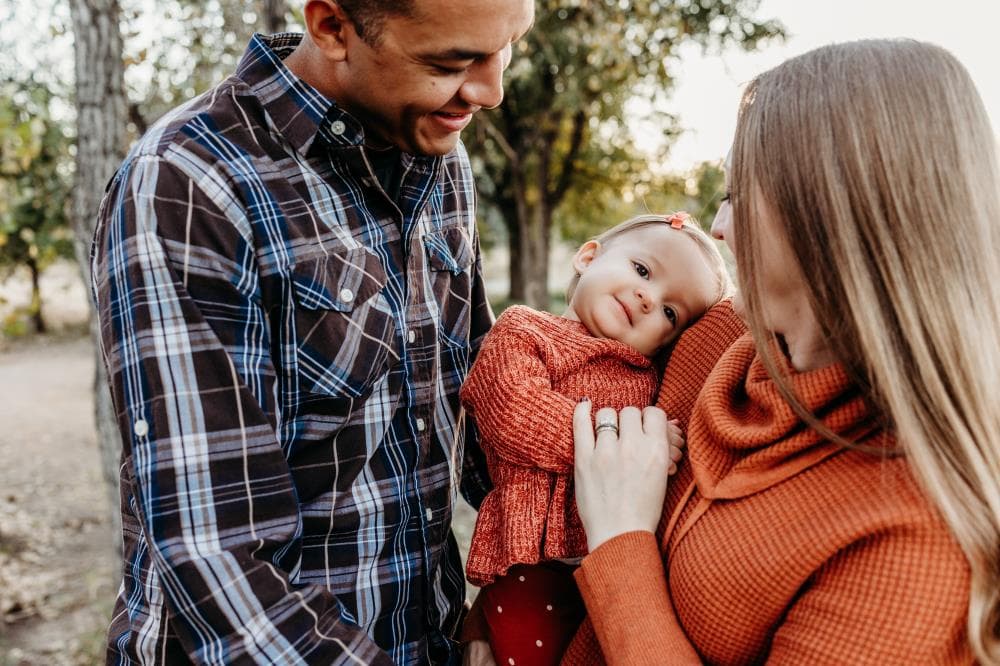 Family of four hugging outdoor portrait session Windsor Colorado