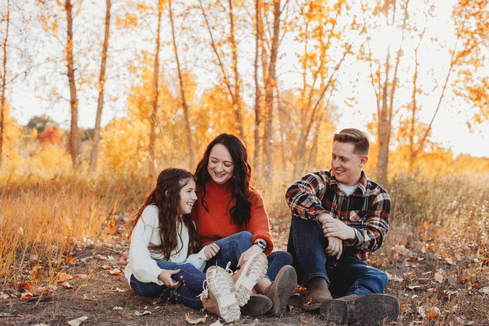 Family of four hugging outdoor portrait session Windsor Colorado