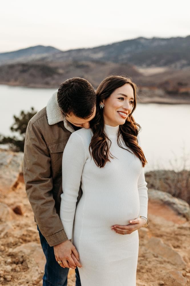 Pregnancy announcement outdoor session wildflower field Colorado