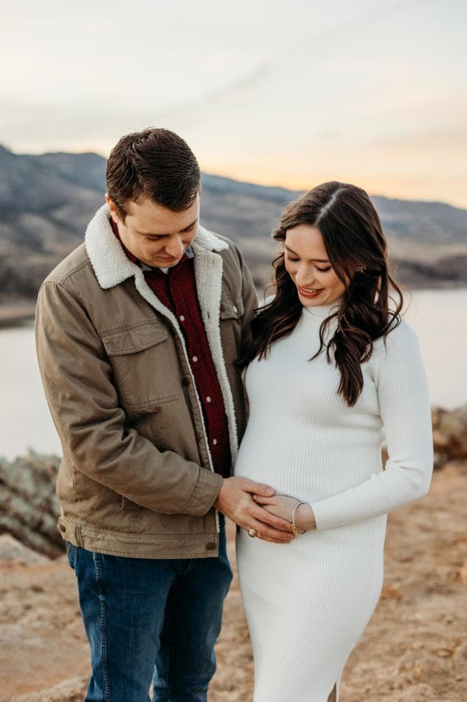 Pregnant mother cradling bump outdoor maternity session Northern Colorado