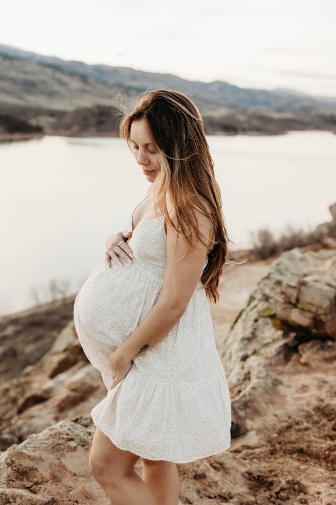 Pregnancy announcement outdoor session wildflower field Colorado