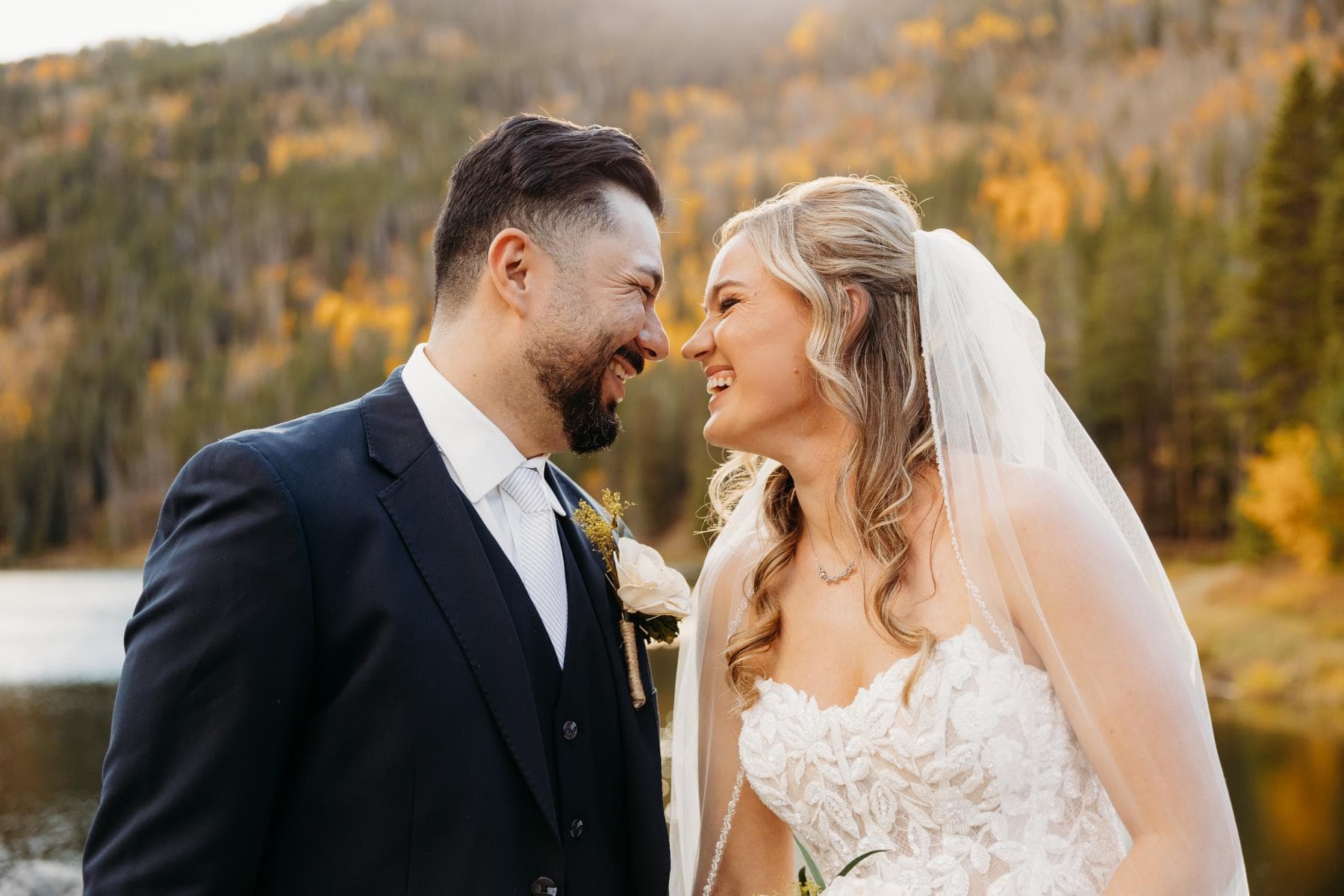 Newlyweds walking hand in hand at sunset Estes Park Colorado