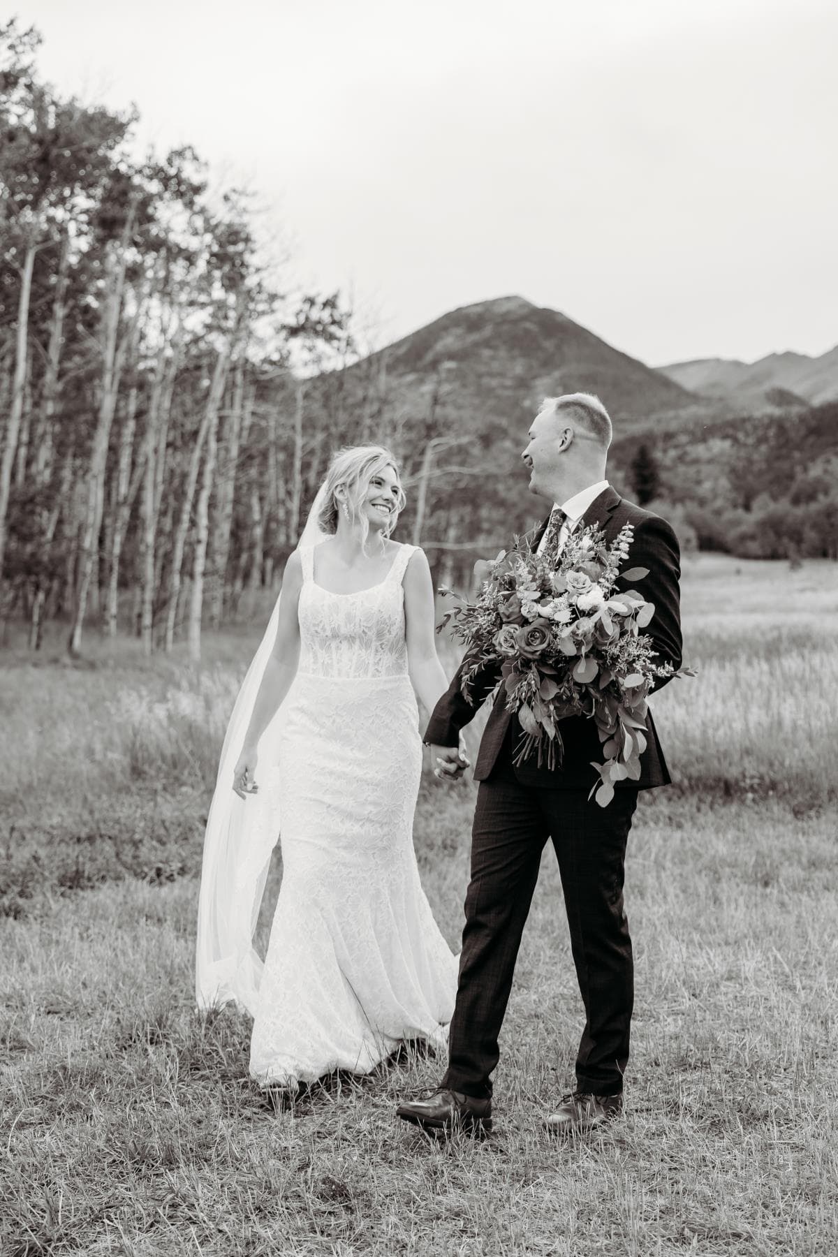 Bride and bridesmaids laughing getting ready Northern Colorado wedding day