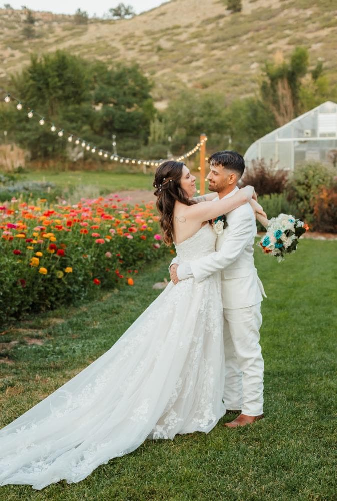 Bride and groom sharing first kiss at outdoor wedding ceremony Colorado