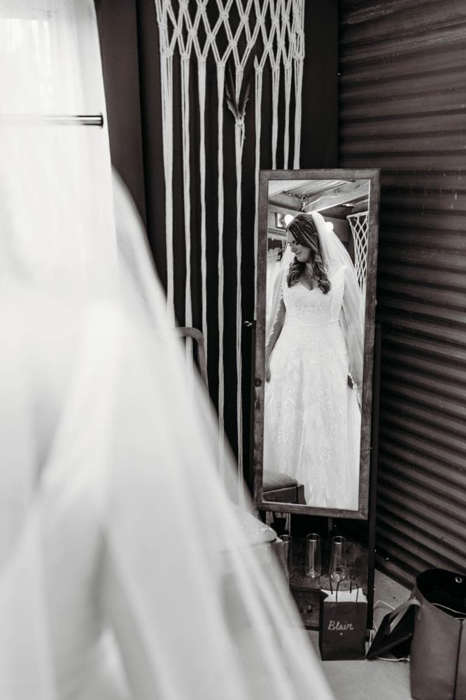 Bride and bridesmaids laughing getting ready Northern Colorado wedding day
