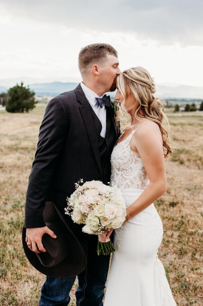 Newlyweds walking hand in hand at sunset Estes Park Colorado